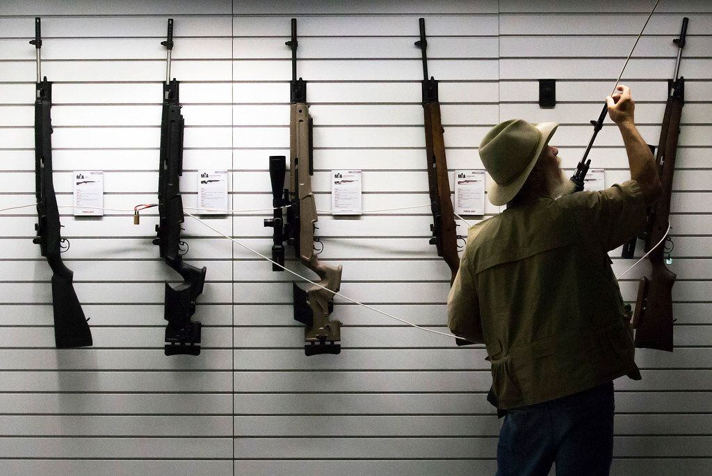 Examiner Jim Fleming uses a wooden dowel to inspect firearms and ensure all are without a...
