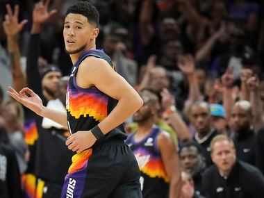 Phoenix Suns guard Devin Booker celebrates after making a 3-pointer during the fourth...