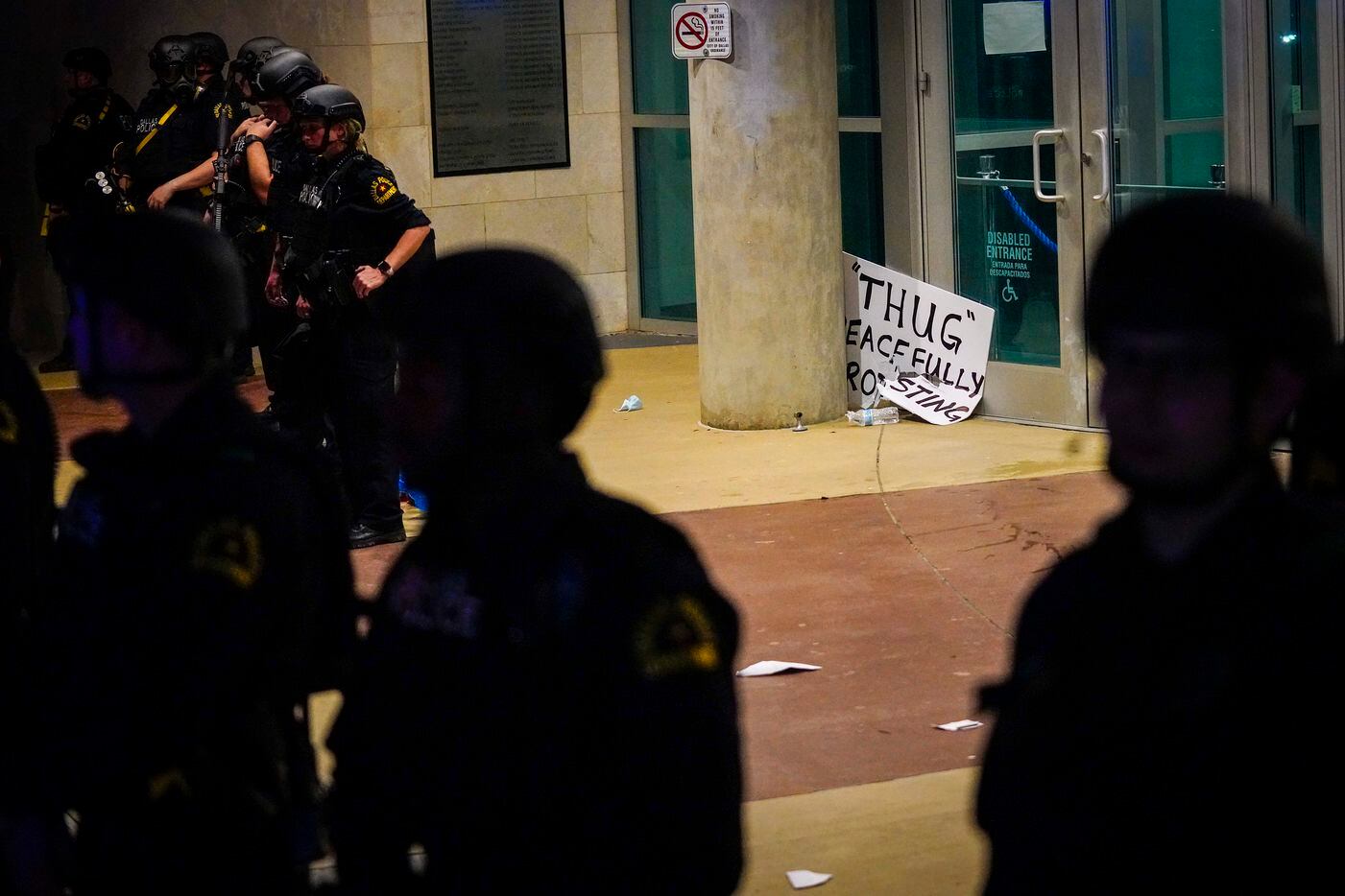 Dallas police form a line outside the front door of the the Dallas Police Headquarters as...