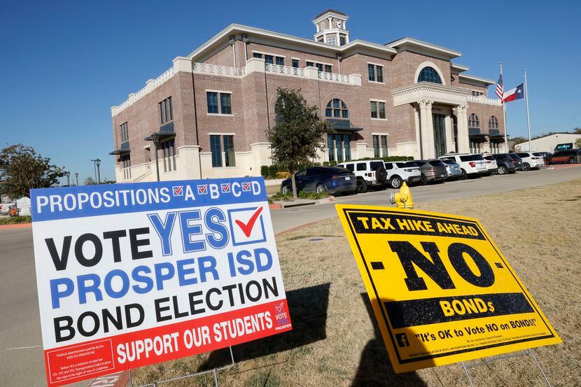 Signs are seen on Election Day in front of Prosper Town Hall where voters cast their...