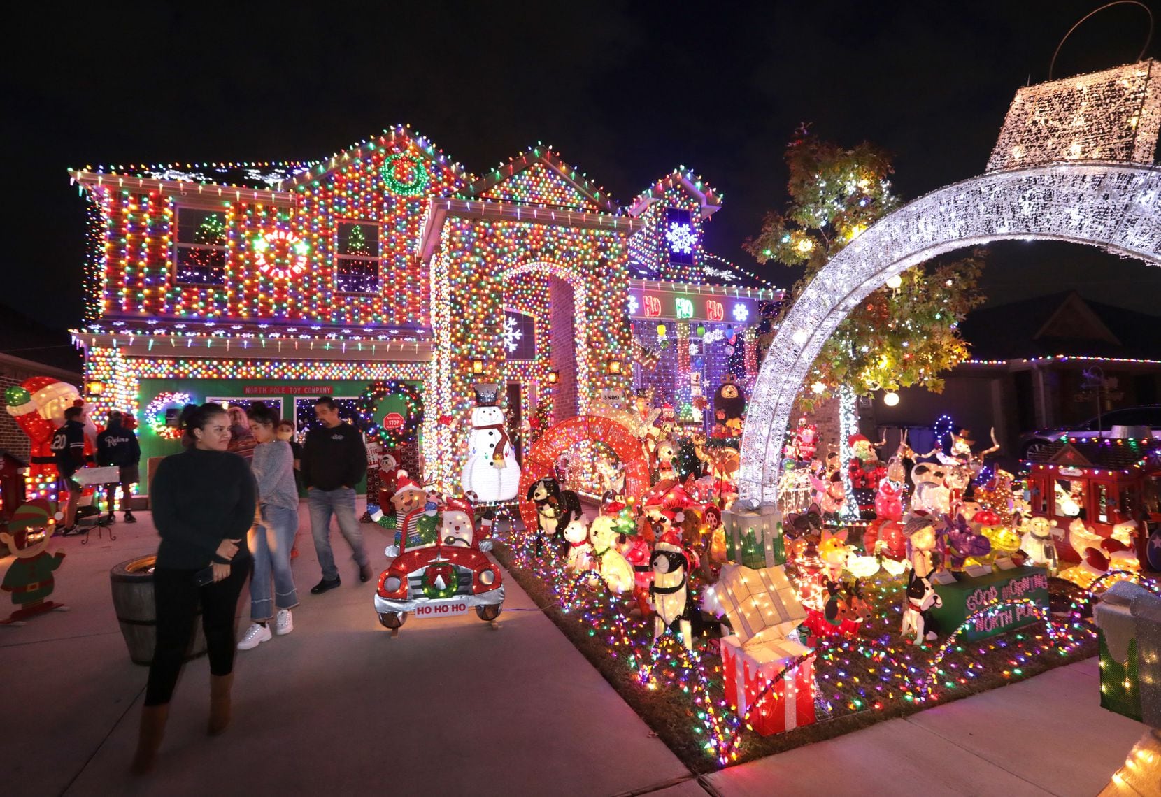 Visitors take in the Burkman family's holiday lights at their Frisco home.