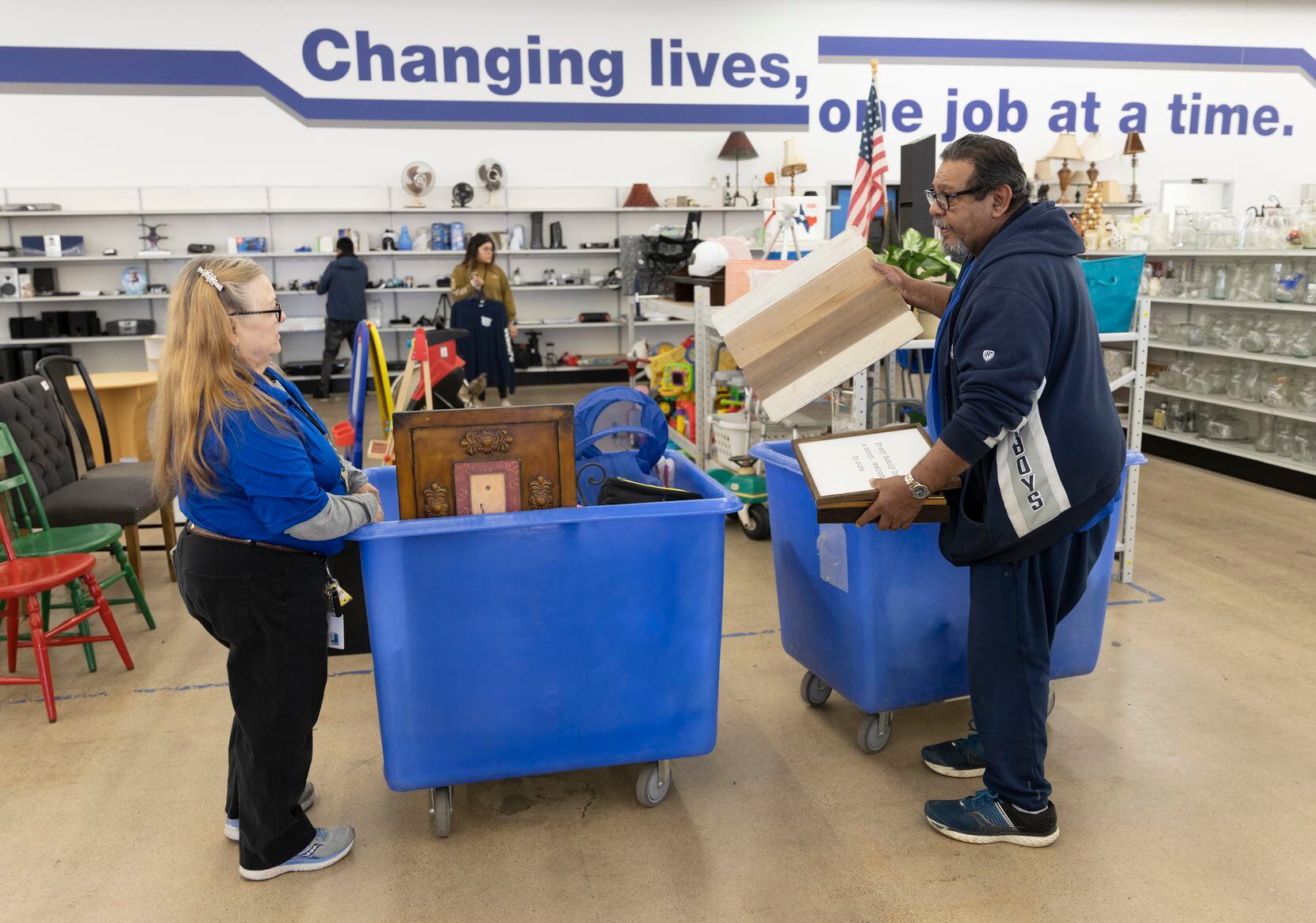 Goodwill employee Darla Rawls and Carlos Lopez discuss where items will be placed on the...