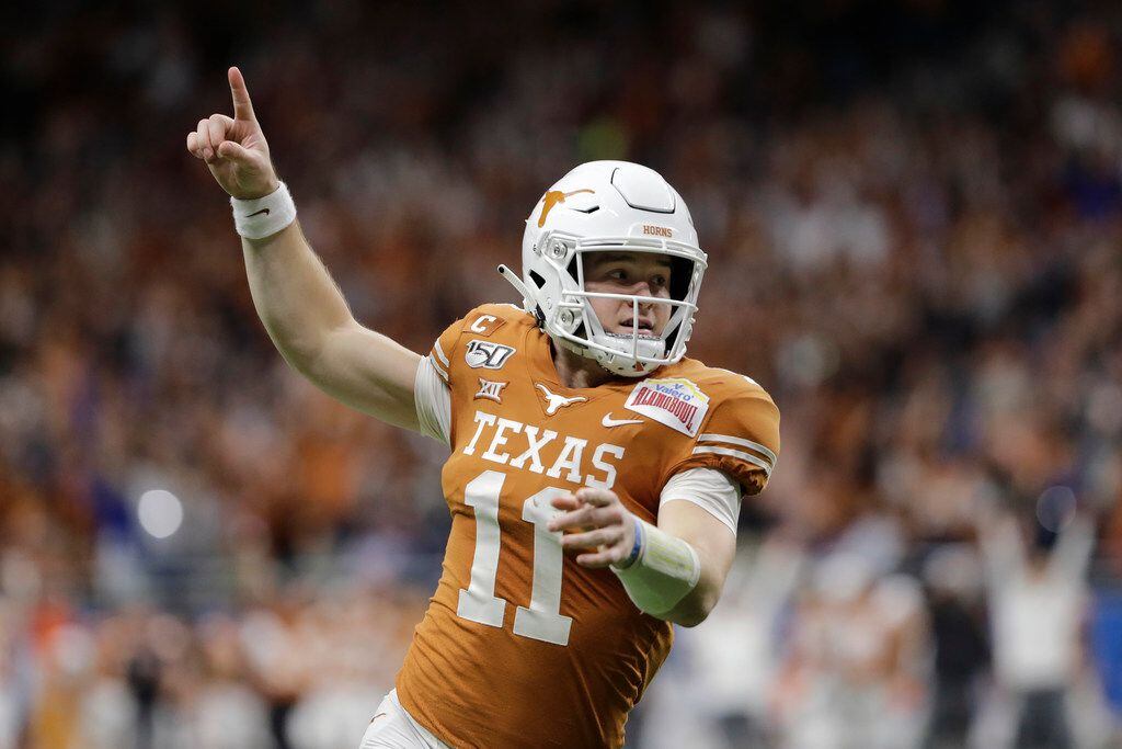 Texas quarterback Sam Ehlinger celebrates a touchdown against Utah during the first half of...