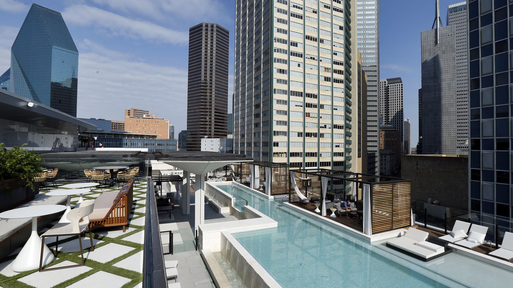 Fountain Place building (left) is seen from the the bar and pool deck areas of The National, a 52-story Elm Street building, which has been renovated into a mixed-use project with hotel rooms, apartments, retail and offices in the old First National Bank Tower in downtown Dallas. (Tom Fox/The Dallas Morning News)