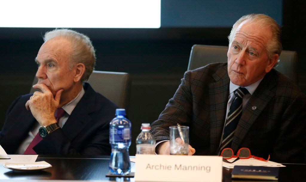 Archie Manning (right) and Roger Staubach listen to a presentation during a meeting to...