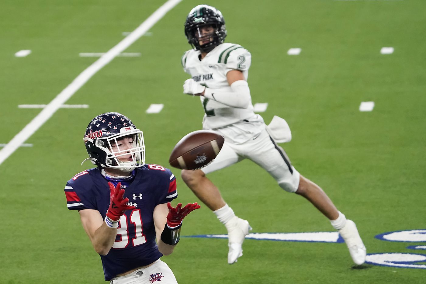 Denton Ryan wide receiver Keagan Cunningham (81) hauls in a 52-yard touchdown pass from quarterback Seth Henigan as Cedar Park defensive back Blake Burton (2) defends during the first half of the Class 5A Division I state football championship game at AT&T Stadium on Friday, Jan. 15, 2021, in Arlington, Texas. (Smiley N. Pool/The Dallas Morning News)