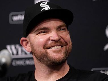 Chicago White Sox's Liam Hendricks smiles as he talks to reporters before a baseball game...