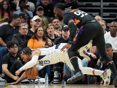 Dallas Mavericks guard Jalen Brunson (13) is fouled by Phoenix Suns forward Jae Crowder (99)...