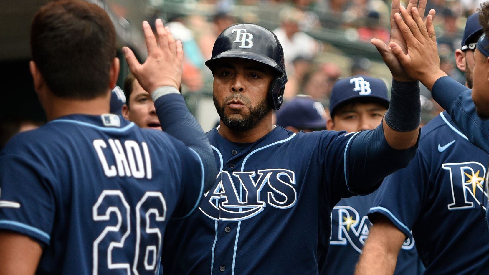 Tampa Bay Rays designated hitter Nelson Cruz, center, is congratulated by teammates after scoring a run on a ground out by Kevin Kiermaier off Detroit Tigers relief pitcher Gregory Soto in the tenth inning of a baseball game, Sunday, Sept. 12, 2021, in Detroit.