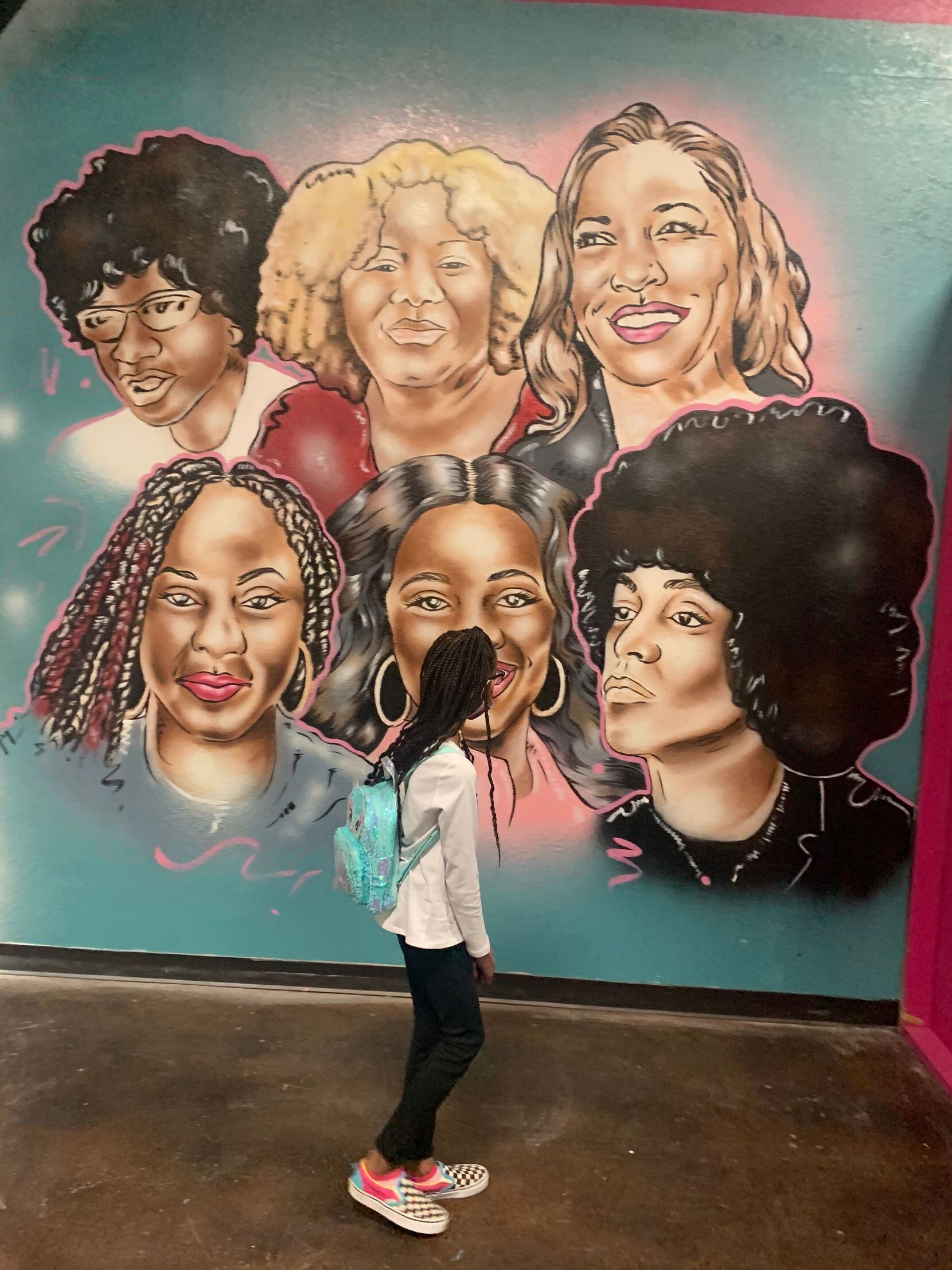 A girl walks by a depiction of Black leaders at the Black Girl Magic Museum in Mesquite....