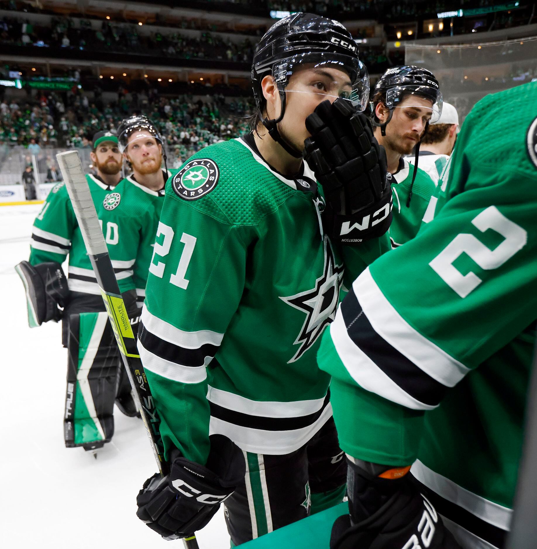 Dallas Stars left wing Jason Robertson (21) leaves the ice with teammates following their...