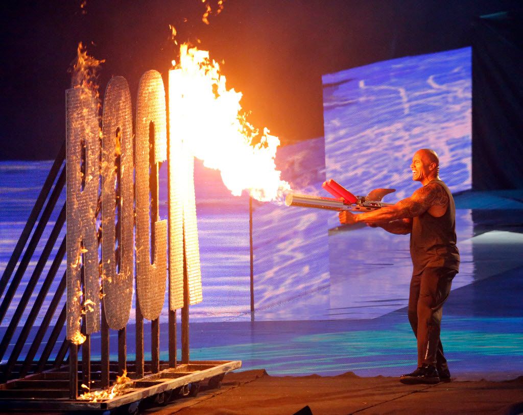 The Rock ignites a set piece on fire during his introduction at WrestleMania 32 at AT&T...