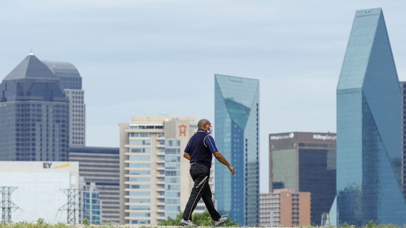 A file photo shows a man walking along the Trinity Levee Trail on Wednesday, Aug. 18, 2021,...