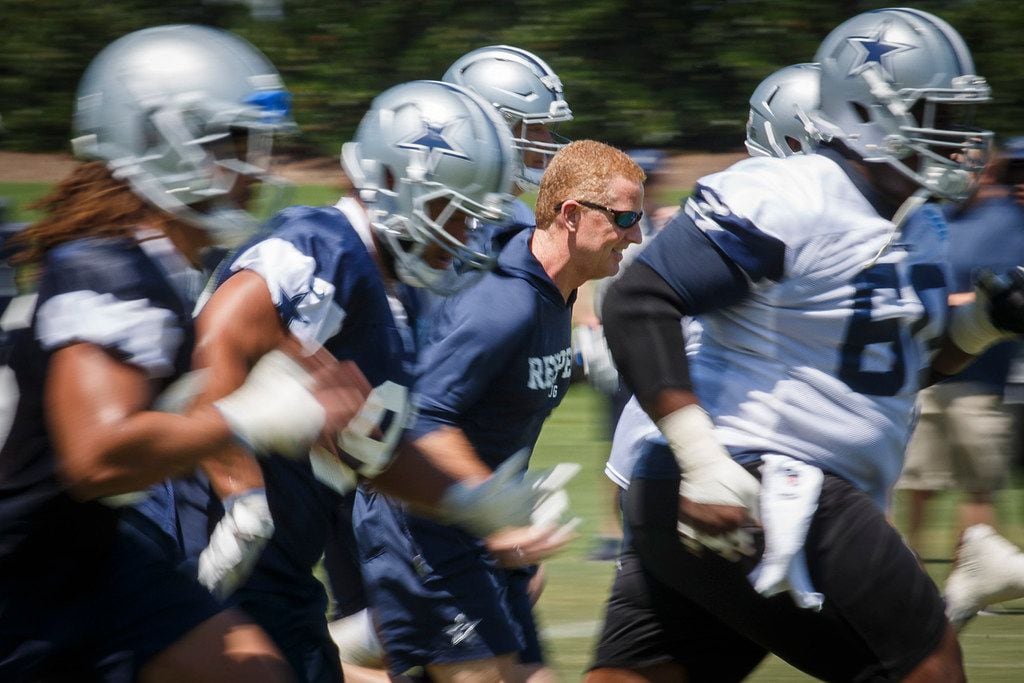 FILE - Dallas Cowboys head coach Jason Garrett runs sprints with his players during the...