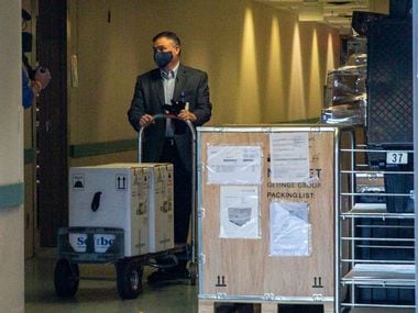 Vice President and Chief Pharmacy Officer Jon Albrecht receives a shipment of the Pfizer COVID-19 vaccine at Methodist Dallas Medical Center on Monday.