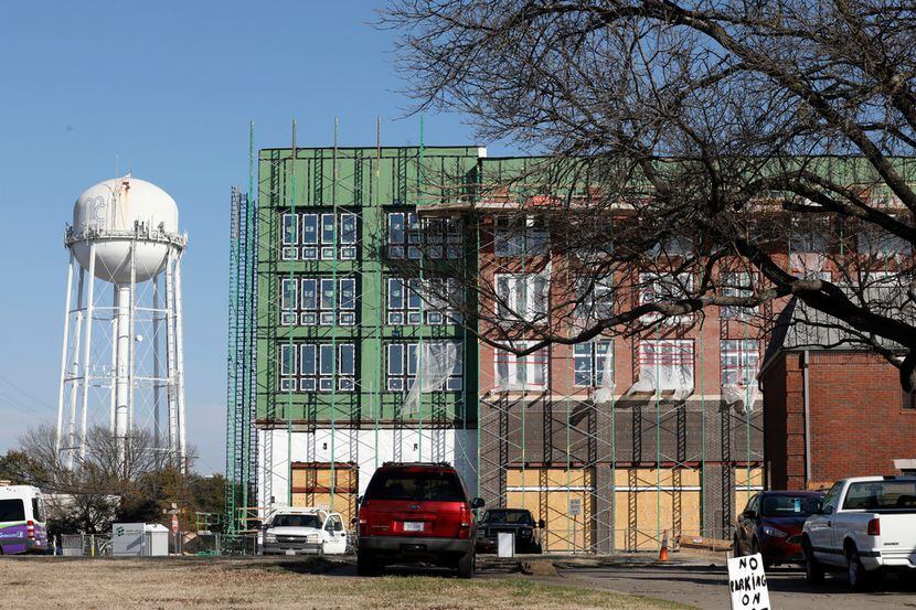 An old McKinney water tower emerges behind new construction in downtown McKinney. Residents...
