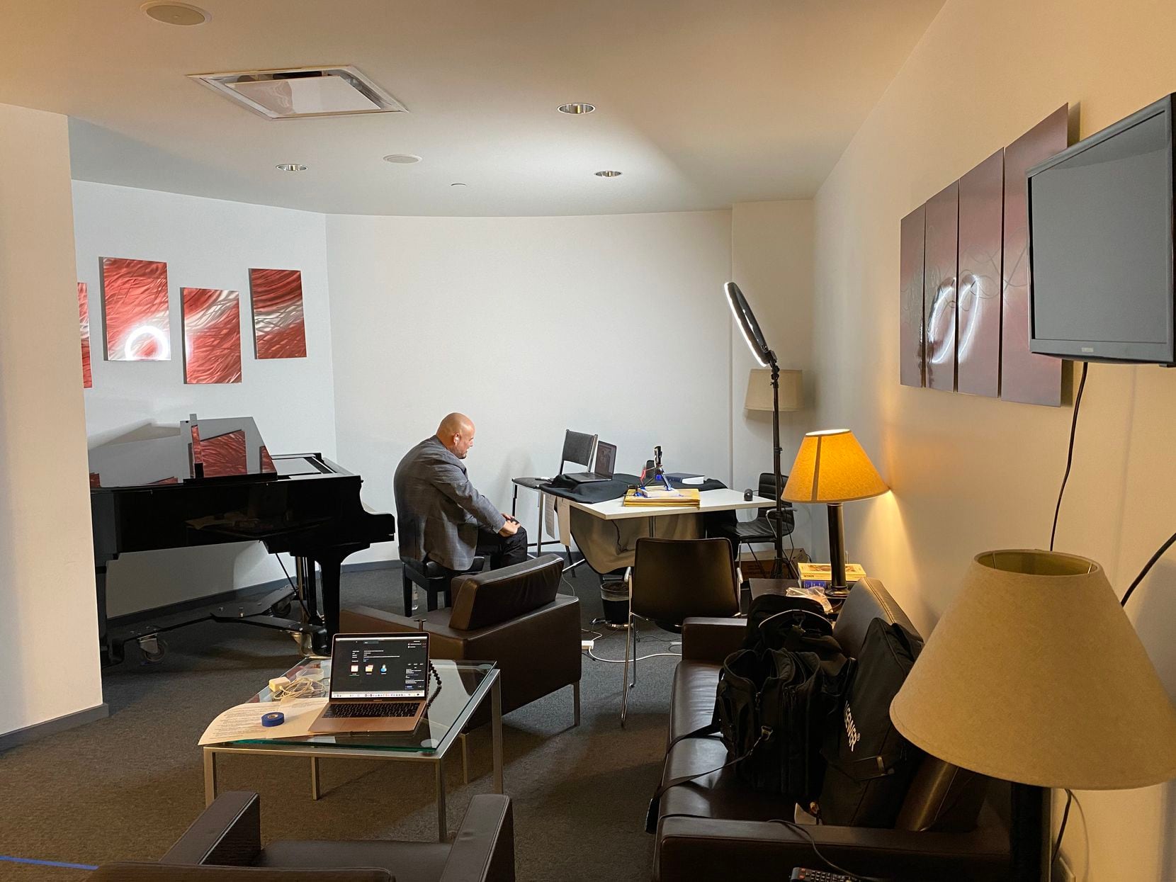 David Lomelí, artistic administrator at the Dallas Opera, is pictured recording a video...