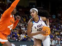 LSU's Angel Reese (10) goes up to shoot over Miami's Kyla Oldacre (44) in the first half of...