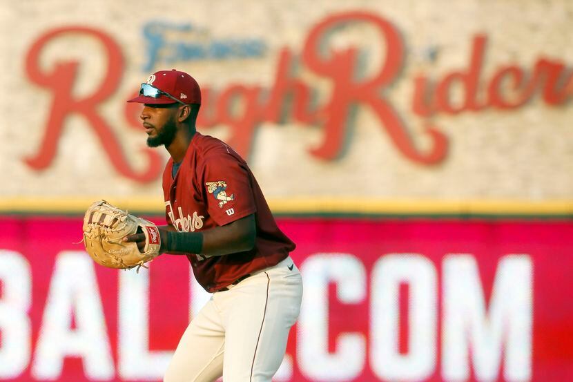 Frisco RoughRiders first baseman Sherten Apostel (12) works to keep a San Antonio baserunner...