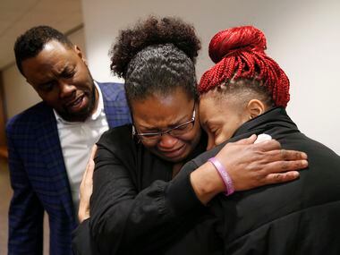 Shaquana Persley (center), mother of slain 13-year-old Shavon Randle, embraced daughter...