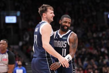 Dallas Mavericks' Luka Doncic and Kyrie Irving react during their team's win over the...
