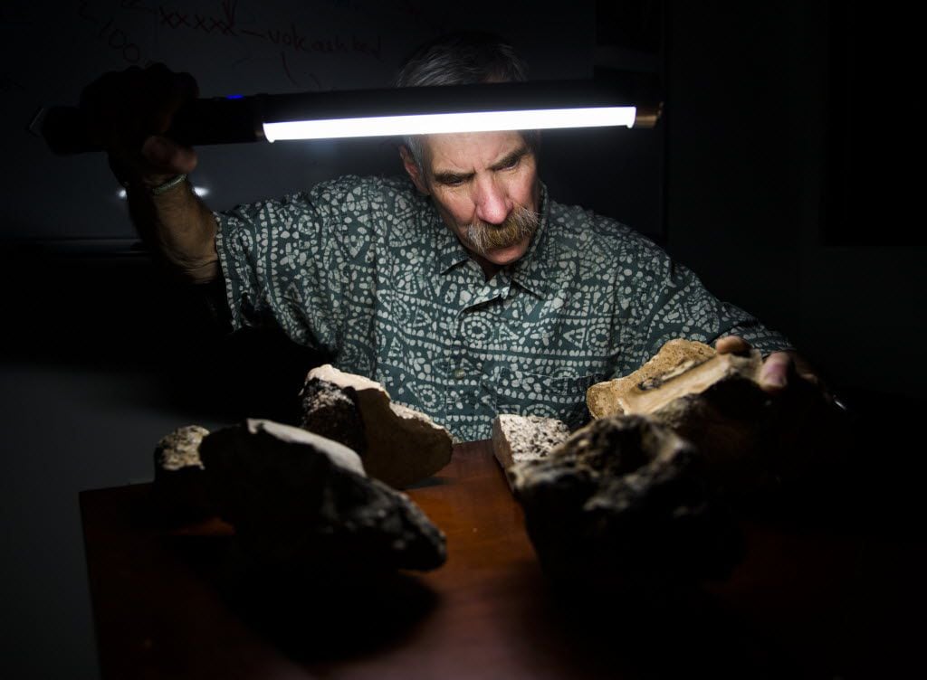 John Geissman, professor of geosciences, with samples of rocks donated by John Tackel in his...