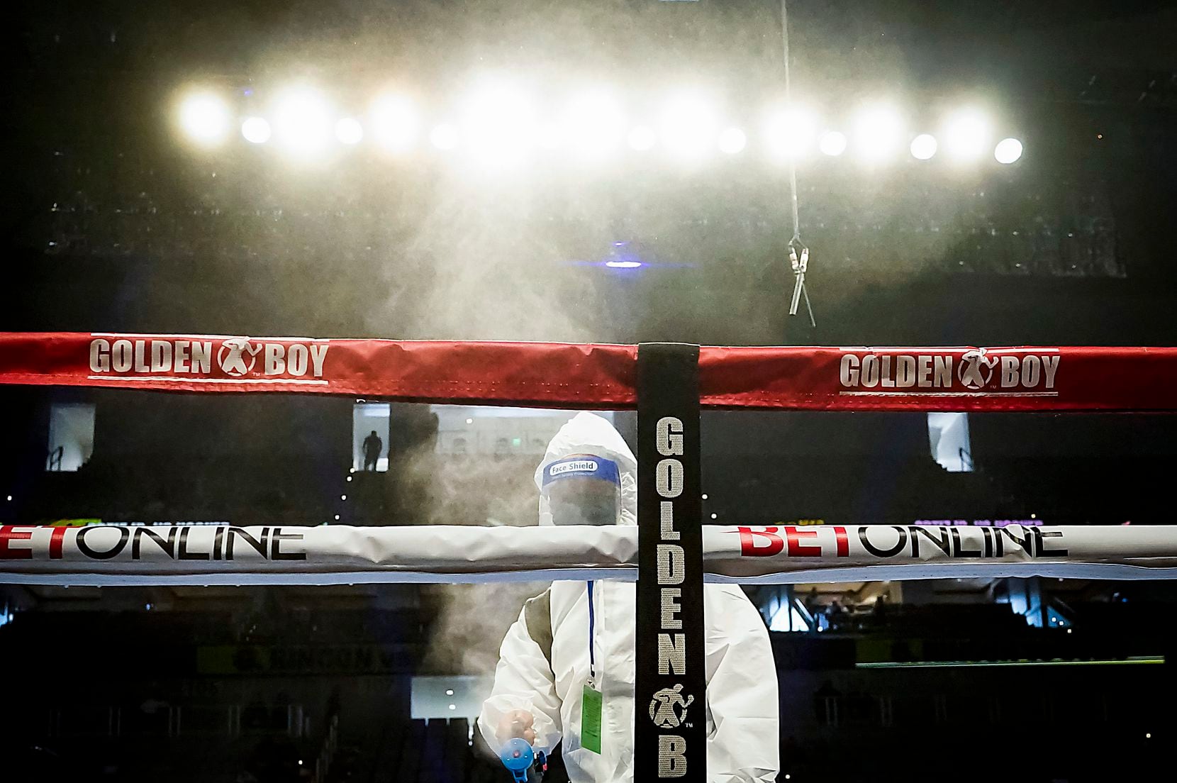 Crews disinfect the ring after Hector Valdez defeated Alberto Torres in a super bantamweight bout at Dickies Arena on Saturday, March 20, 2021, in Fort Worth.