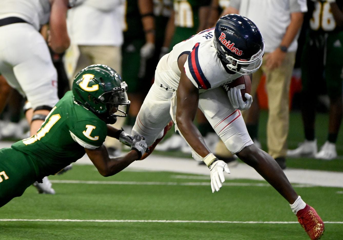 Denton Ryan’s Anthony Hill Jr. (6) runs through a tackle attempt by Longview’s Ta’Darion Boone (11) in the second half during a high school football game between Longview and Denton Ryan, Saturday, Aug. 28, 2021, in Frisco, Texas. Denton Ryan won 40-7. (Matt Strasen/Special Contributor)