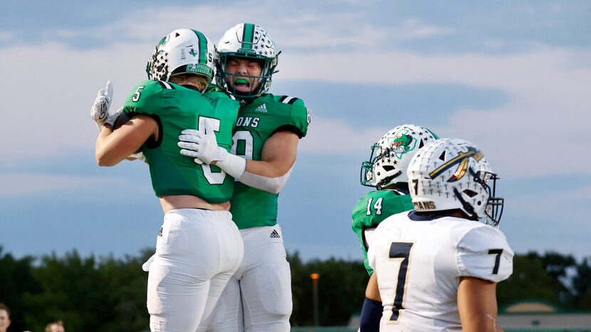 Southlake Carroll running back James Lehman (5) is congratulated by tight end Harrison Moore...