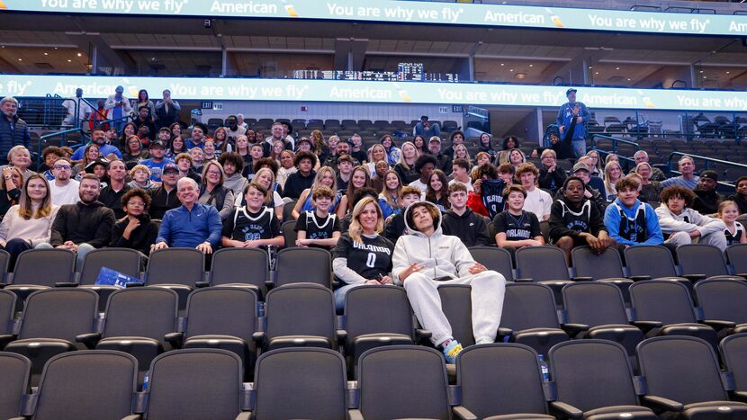 Jennifer Black (center left) sits next to her son Orlando Magic guard Anthony Black and...