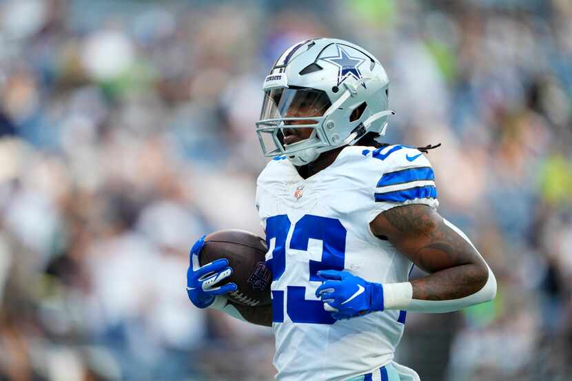 Dallas Cowboys running back Rico Dowdle warms up before a preseason NFL football game...