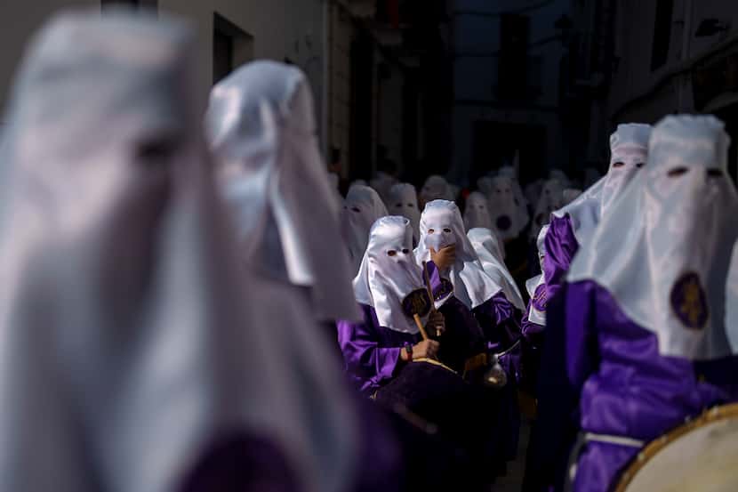 Hooded penitents of the "Padre Jesus Nazareno" brotherhood take part in the holy week...