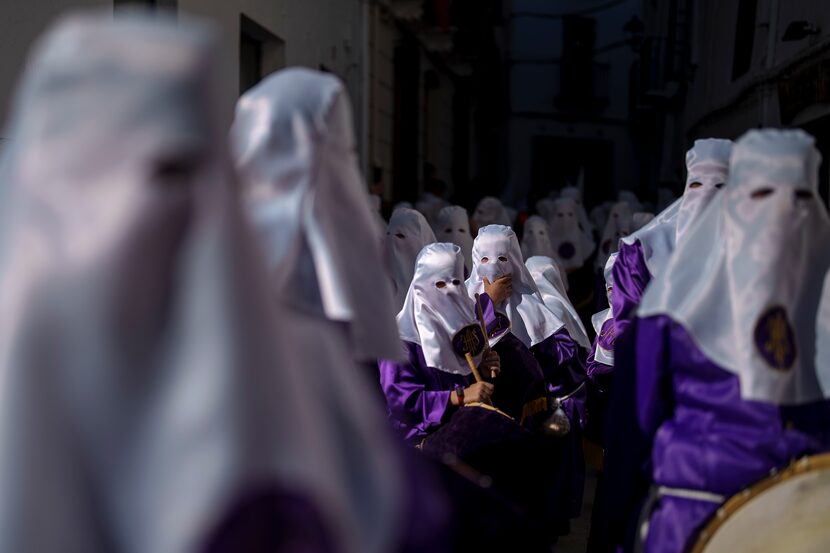 Hooded penitents of the "Padre Jesus Nazareno" brotherhood take part in the holy week...