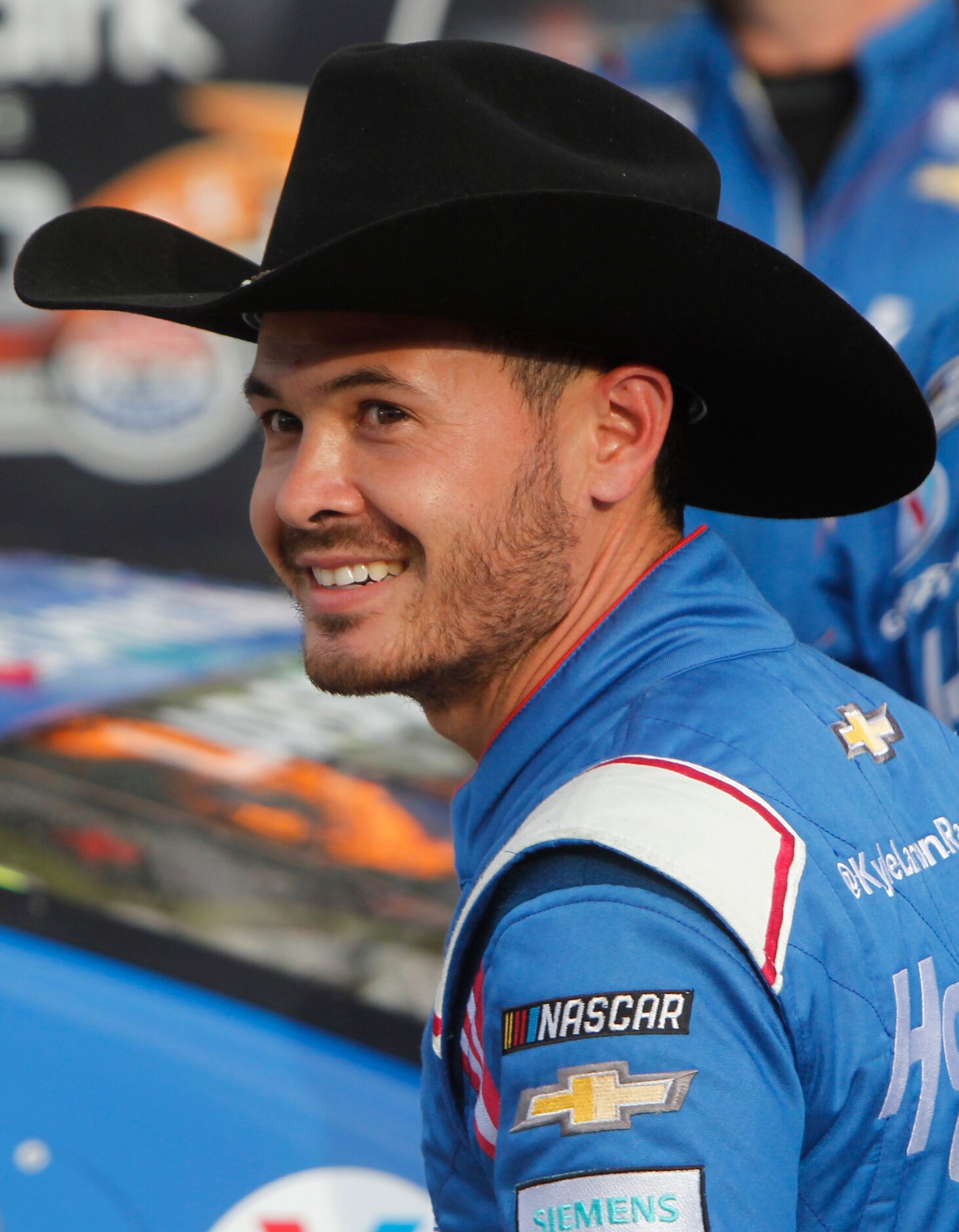 Driver Kyle Larson sports a smile after his victory from behind the wheel of the number 5...