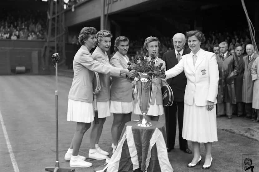 The victorious American tennis team pose with the Wightman Cup after beating Great Britain...