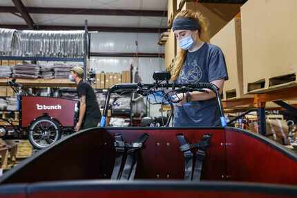 Lidia Banyai checks the quality of bikes after being assembled at Bunch Bikes in Denton on...