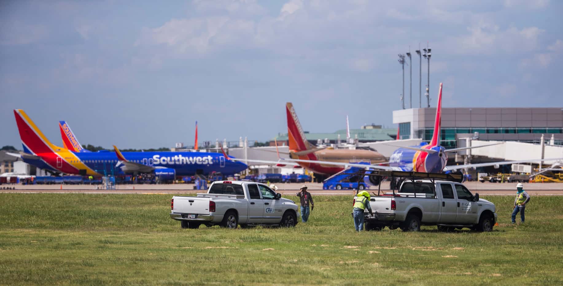 CP&Y, Inc. employees work as Southwest Airlines airplanes are parked at terminals while...