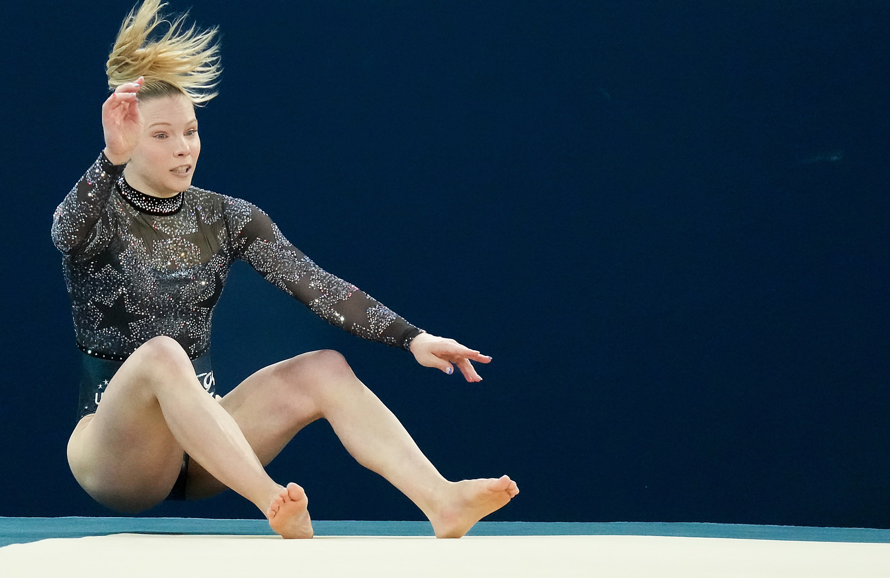 Jade Carey of the United States falls out of bounds while competing on the floor during...