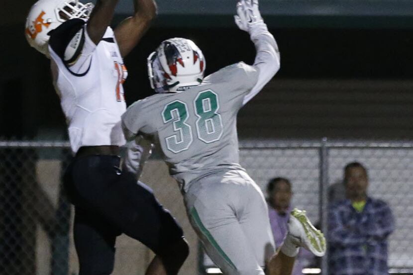 Lancaster wide receiver Omar Manning (15) catches a pass for a touchdown over a Waxahachie...