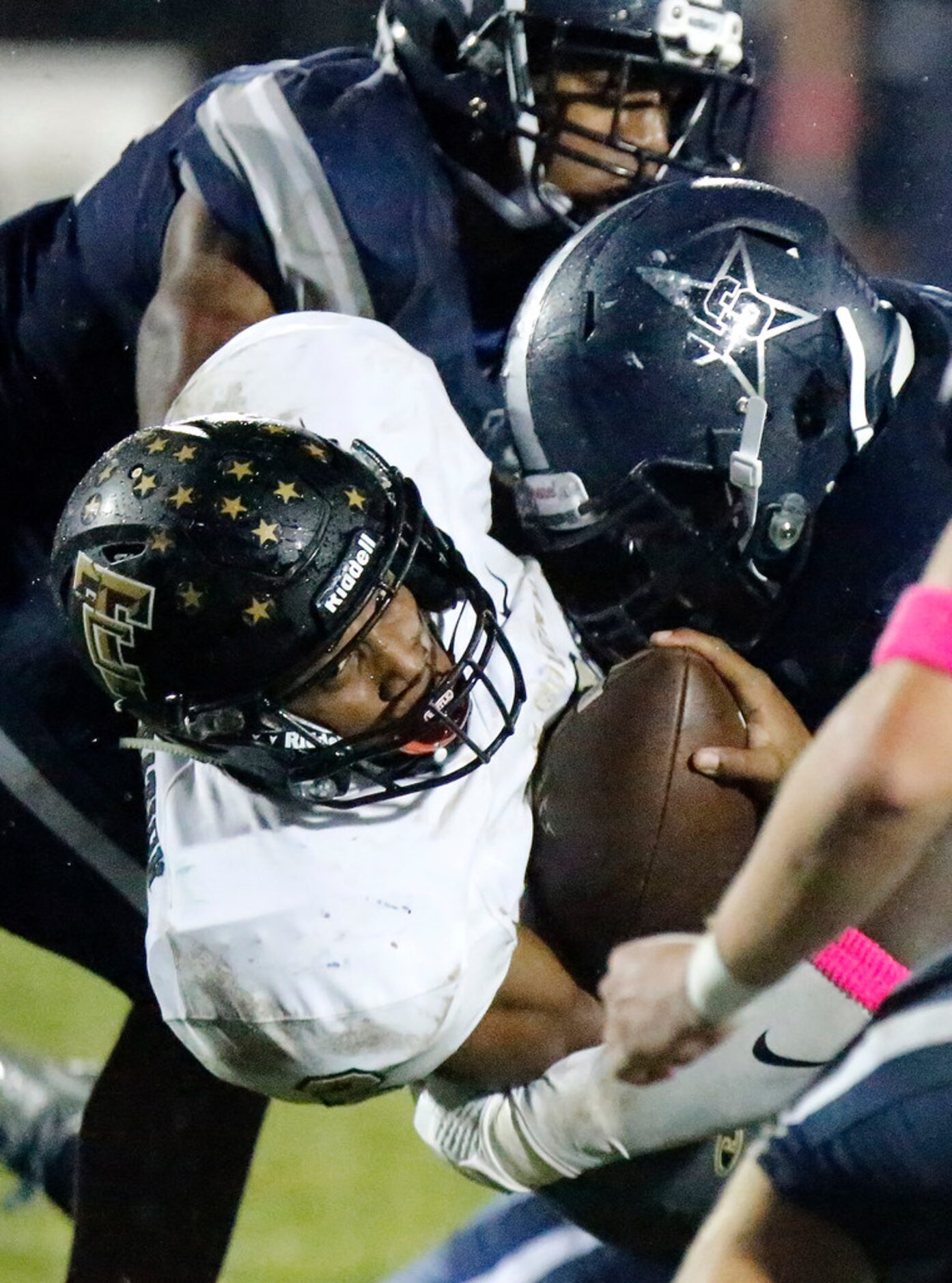 The Colony High School running back Myles Price (2) is wrapped up by Lone Star High School...