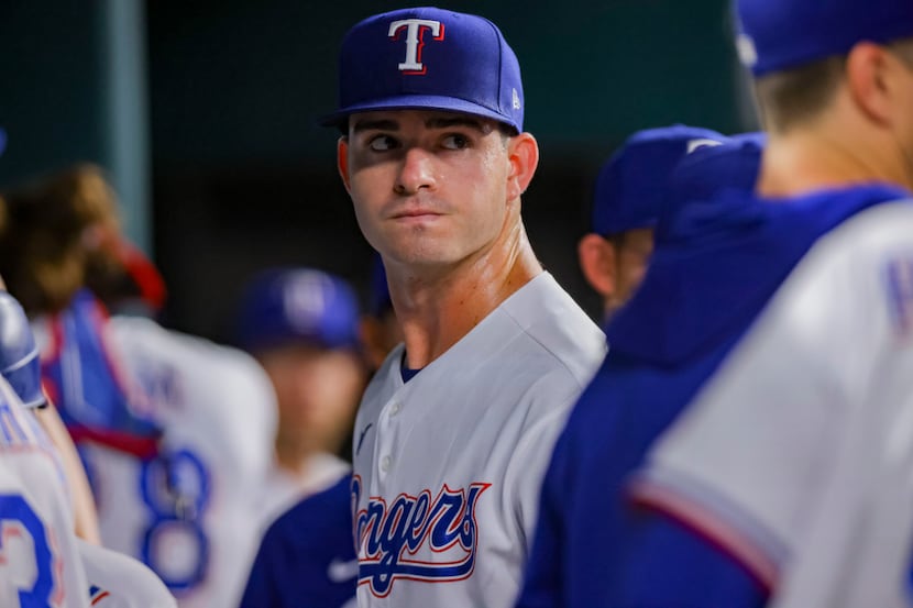 Texas Rangers pitcher Cody Bradford looks on from the dugout after the first inning of a...