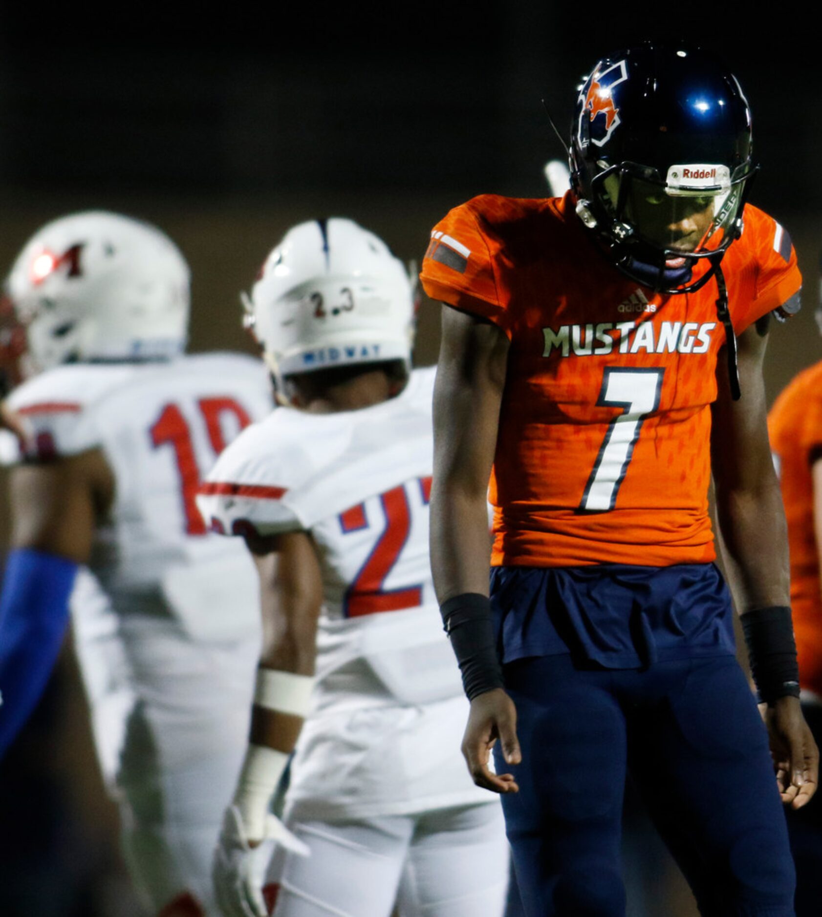 Sachse quarterback Derrick Rose (7) seeks a peek toward the Mustangs bench after fumbling...