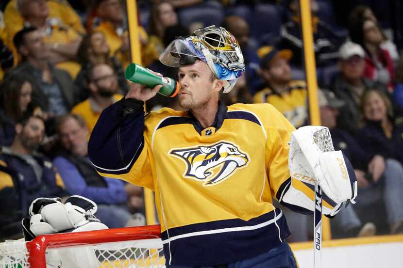 Nashville Predators goalie Pekka Rinne, of Finland, takes a drink during the first period of...