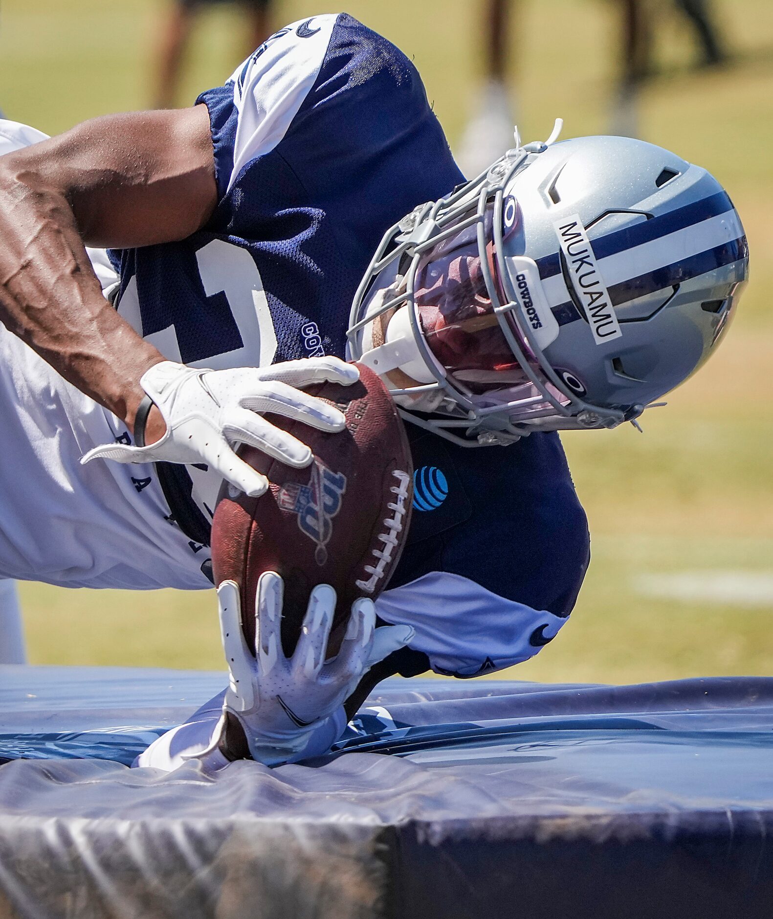 Dallas Cowboys cornerback Israel Mukuamu reaches for a ball in a drill during a practice at...