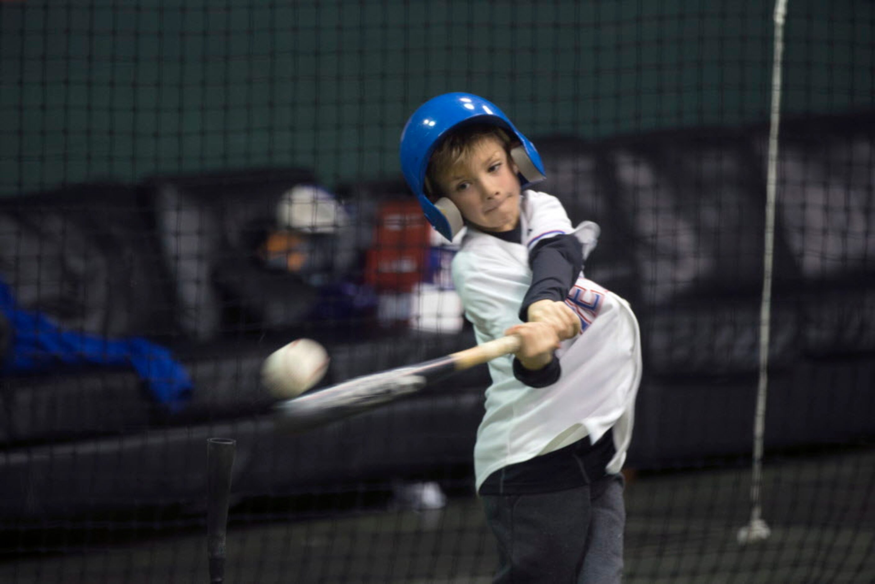 With a crack, Major Milam, 8, of Royce City, Texas smashes a baseball of a tee, sending down...