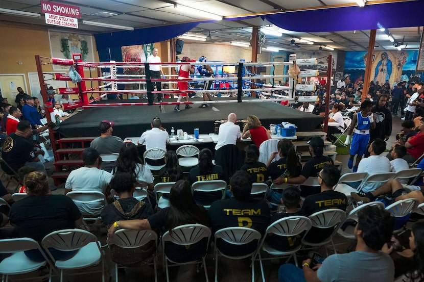 Angel Garcia (in blue) of Maple Avenue fights Isaac Becerra (in red) of GTO  during a boxing...