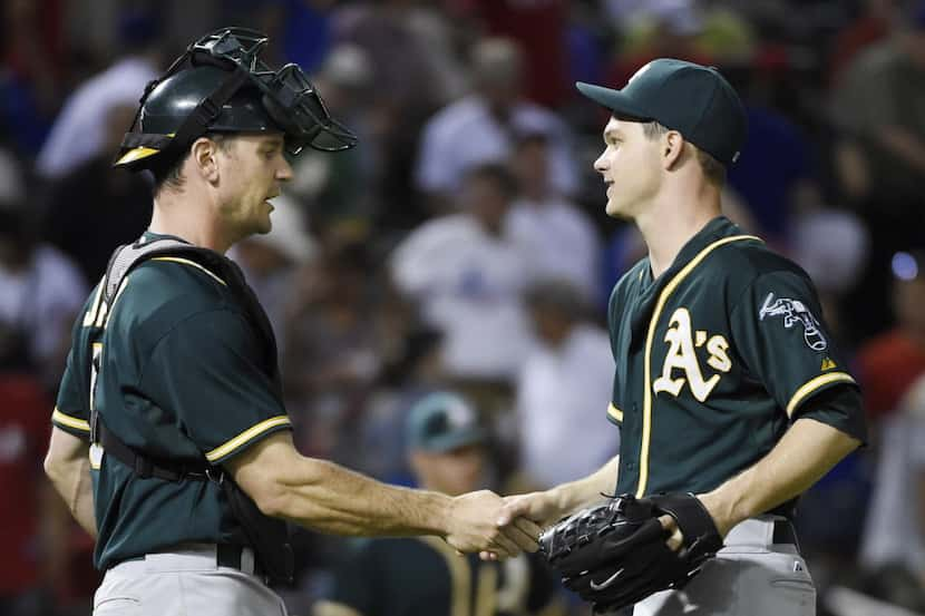 Oakland Athletics catcher John Jaso (5) congratulates Oakland Athletics starting pitcher...