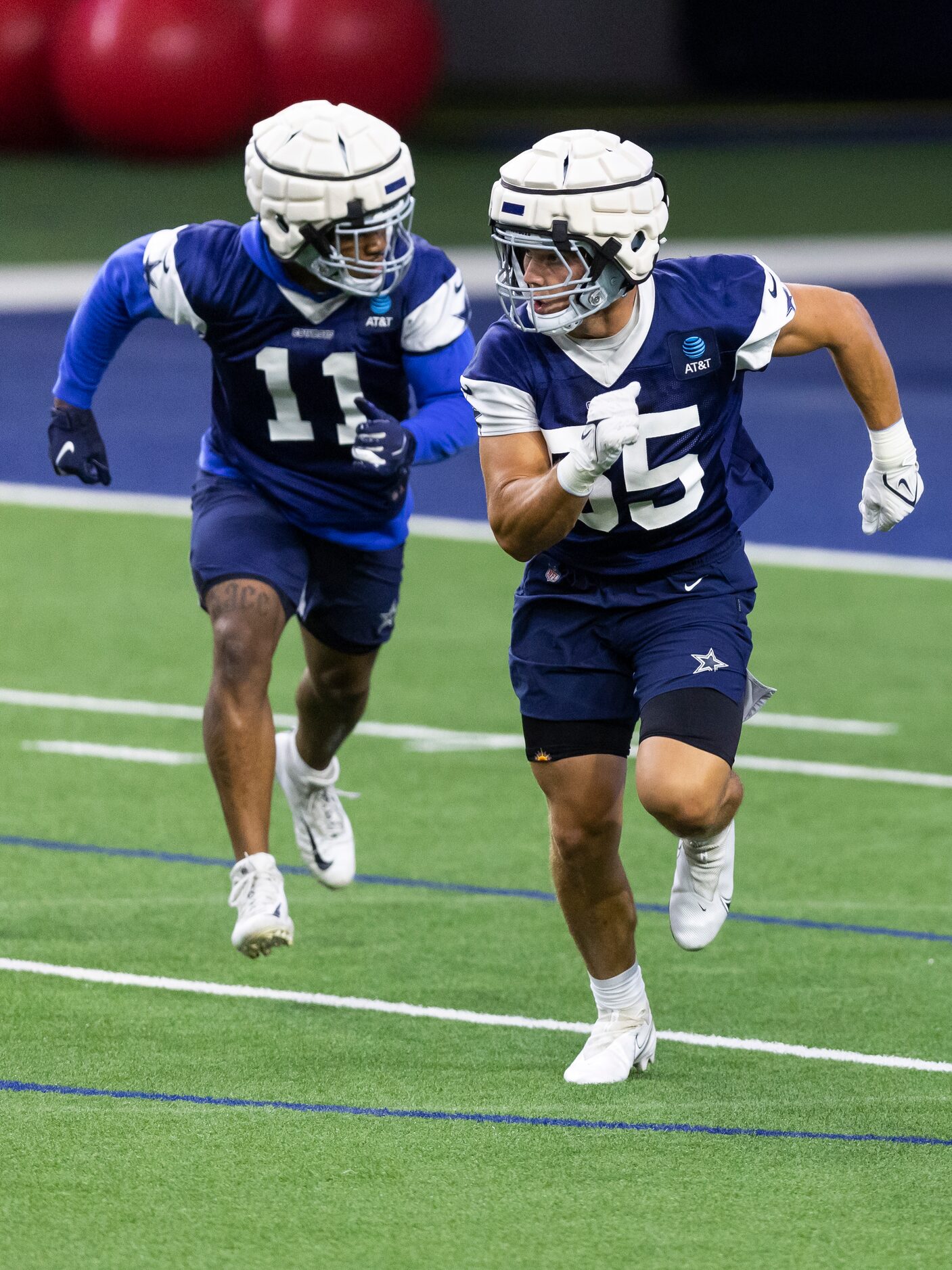 Dallas Cowboys linebackers Micah Parsons (11) and Leighton Vander Esch (55) run a drill...