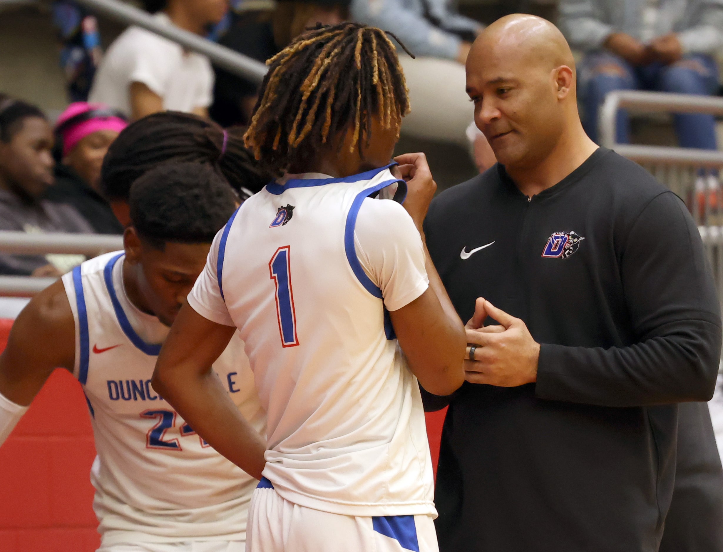 Duncanville head coach David Peavy speaks with guard Xavion Lawson (1) during a timeout...