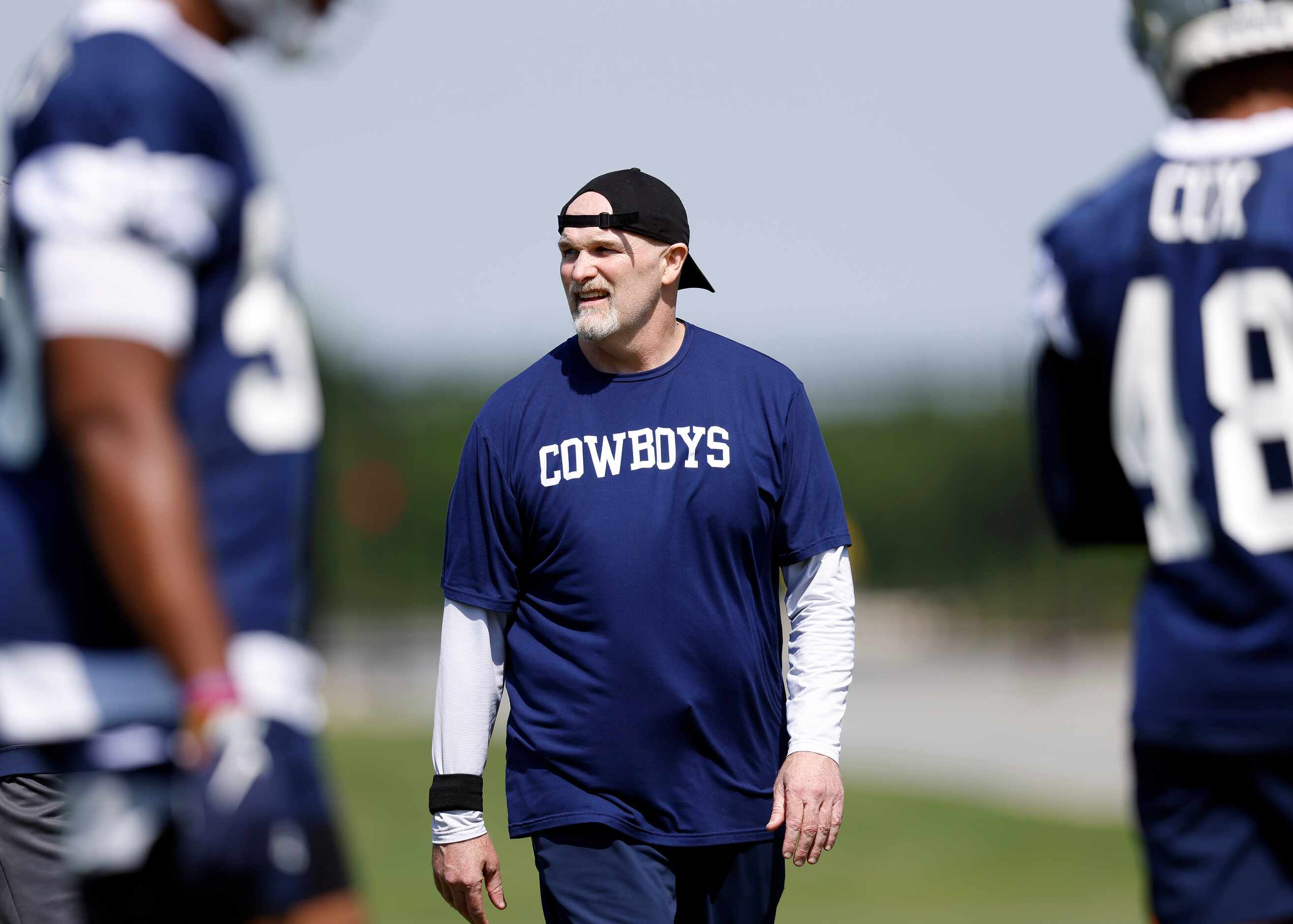 Dallas Cowboys defensive coordinator Dan Quinn watches his players during rookie minicamp at...